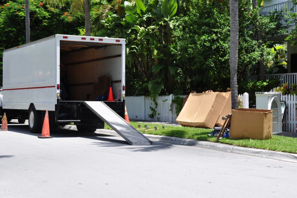 moving truck with the back open and ramp out for movers to carry items into it.