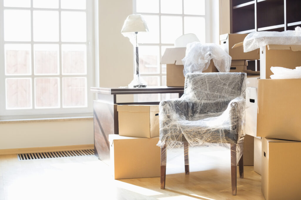 furniture being prepared to move out of a home as it is wrapped up and boxed up