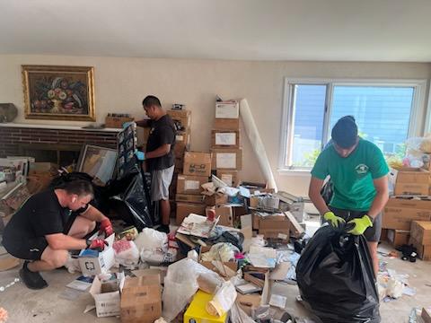 flannery's handymen team helping clean up a hoarder home with hoarding cleanout services