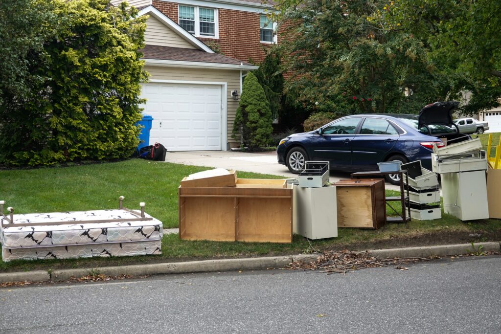 junk removal items ready by the homes curb for pickup